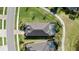 Aerial view of a luxury home featuring a spacious layout, screened pool, and landscaped grounds at 25325 Longmeadow Dr, Punta Gorda, FL 33955