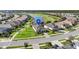 Aerial view of houses in a neighborhood, a pond, and a golf course in the distance at 25325 Longmeadow Dr, Punta Gorda, FL 33955