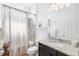 Well-lit bathroom features a shower-tub combo and vanity with granite counters at 25325 Longmeadow Dr, Punta Gorda, FL 33955