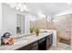 Bathroom with double vanity, granite countertops, and a tiled walk-in shower at 25325 Longmeadow Dr, Punta Gorda, FL 33955