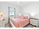 Cozy bedroom features a ceiling fan, window, and traditional furnishings at 25325 Longmeadow Dr, Punta Gorda, FL 33955