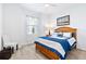 Bedroom featuring a wooden bed frame and bright, natural light at 25325 Longmeadow Dr, Punta Gorda, FL 33955