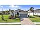 Charming single-story home with lovely landscaping and a brick driveway leading to a two-car garage at 25325 Longmeadow Dr, Punta Gorda, FL 33955