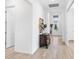 Bright hallway featuring wood-look tile floors, decorative console table, and front door view at 25325 Longmeadow Dr, Punta Gorda, FL 33955
