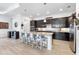 Modern kitchen island featuring granite countertops, dark cabinets, and barstool seating at 25325 Longmeadow Dr, Punta Gorda, FL 33955