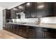Gourmet kitchen featuring granite countertops, dark cabinets, and modern stainless steel appliances at 25325 Longmeadow Dr, Punta Gorda, FL 33955