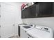 Laundry room with washer, dryer, granite countertop, and cabinet storage at 25325 Longmeadow Dr, Punta Gorda, FL 33955