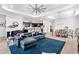 Open-concept living area showcases a large blue sectional, kitchen island, and dining set at 25325 Longmeadow Dr, Punta Gorda, FL 33955
