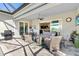 Inviting covered patio with outdoor seating and views of the yard at 25325 Longmeadow Dr, Punta Gorda, FL 33955