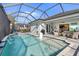 Beautiful pool and patio area, perfect for entertaining, with outdoor kitchen and comfortable lounging at 25325 Longmeadow Dr, Punta Gorda, FL 33955