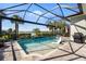 Gorgeous pool featuring a waterfall feature, in-pool seating and a lovely view of the surrounding landscape at 25325 Longmeadow Dr, Punta Gorda, FL 33955