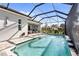 Stunning pool with relaxing waterfall and inviting outdoor seating area with beautiful patio at 25325 Longmeadow Dr, Punta Gorda, FL 33955
