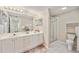 Bright bathroom with double sinks, a large mirror, vanity and glass-enclosed shower at 2625 Terra Ceia Bay Blvd # 206, Palmetto, FL 34221