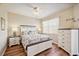 Bright bedroom with coastal decor, white furniture, ceiling fan, and hardwood floors at 2625 Terra Ceia Bay Blvd # 206, Palmetto, FL 34221