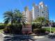 Estuaries II building exterior with lush tropical landscaping against a clear blue sky at 2625 Terra Ceia Bay Blvd # 206, Palmetto, FL 34221