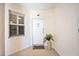Image of entry door to unit 206 with neutral walls, fern, and window at 2625 Terra Ceia Bay Blvd # 206, Palmetto, FL 34221