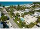 Aerial view of the property near a beach, showcasing the pool, surrounding greenery and neighborhood at 3000 Gulf Dr # 3, Holmes Beach, FL 34217