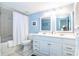 Bright bathroom with double sinks, white cabinetry, and shower with a tub, ideal for everyday use at 3000 Gulf Dr # 3, Holmes Beach, FL 34217