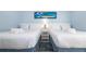Comfortable bedroom featuring two beds, soft lighting, and calming decor for a relaxing stay at 3000 Gulf Dr # 3, Holmes Beach, FL 34217