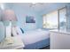 Cozy bedroom with blue walls, white bedding, and nautical-themed decor for a relaxing atmosphere at 3000 Gulf Dr # 3, Holmes Beach, FL 34217