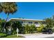 Two-story condo complex featuring well-maintained landscaping, mature trees, and assigned parking at 3000 Gulf Dr # 3, Holmes Beach, FL 34217