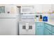 A close up of an updated kitchen featuring modern white appliances, ample counter space, and a stylish design at 3000 Gulf Dr # 3, Holmes Beach, FL 34217