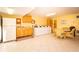 Bright community laundry room with multiple machines, sink, and adjacent seating area at 3000 Gulf Dr # 3, Holmes Beach, FL 34217