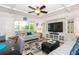 Cozy living room with coastal décor, a modern ceiling fan, and an open floor plan at 3000 Gulf Dr # 3, Holmes Beach, FL 34217