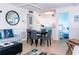 Charming living room with tile flooring, dining area, and a glimpse into the adjacent bright white kitchen at 3000 Gulf Dr # 3, Holmes Beach, FL 34217