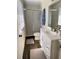 Bright bathroom with a shower, toilet, vanity and decorative bath mats at 306 Barlow Ave # 77, Sarasota, FL 34232