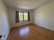 Bright, sunlit bedroom featuring wood laminate flooring and a window at 306 Barlow Ave # 77, Sarasota, FL 34232