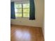 Sunlit bedroom with wood laminate flooring and a window at 306 Barlow Ave # 77, Sarasota, FL 34232