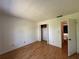 Spacious bedroom with wood laminate flooring and an open closet at 306 Barlow Ave # 77, Sarasota, FL 34232