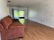 Open-concept living room with hardwood floors, flowing to a serene outdoor view for relaxed living at 306 Barlow Ave # 77, Sarasota, FL 34232