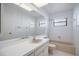 Well-lit bathroom with a large mirror, tub-shower combo, and neutral color scheme at 3640 Aster Dr, Sarasota, FL 34233