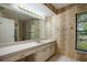 Well-lit bathroom with bamboo wallpaper, large mirror and ample counter space at 3640 Aster Dr, Sarasota, FL 34233