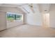 Bright bedroom featuring a vaulted ceiling, built-in shelving, and neutral carpet at 3640 Aster Dr, Sarasota, FL 34233