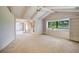 Airy bedroom features a vaulted ceiling with exposed beams, large windows, and built-in shelving at 3640 Aster Dr, Sarasota, FL 34233
