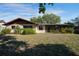 Charming home exterior with a well-manicured lawn and mature landscaping at 3640 Aster Dr, Sarasota, FL 34233