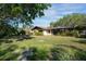 Charming home exterior with a well-manicured lawn and mature landscaping at 3640 Aster Dr, Sarasota, FL 34233