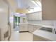Bright kitchen featuring white appliances, ample cabinet space, and a ceiling fan at 3640 Aster Dr, Sarasota, FL 34233