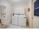 Functional laundry room featuring a sink, washer, dryer, and storage cabinet at 3640 Aster Dr, Sarasota, FL 34233