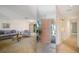 Spacious living room with large mirror, providing an open feel and view of the front door and entryway at 3640 Aster Dr, Sarasota, FL 34233