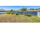 Expansive backyard featuring well-maintained lawn and tranquil pond view at 3663 Quiet Dr, Sarasota, FL 34240