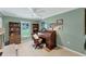 Home office featuring dark wood desk, tile flooring, neutral paint and a ceiling fan at 3979 Helene St, Sarasota, FL 34233