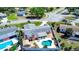 Aerial view of the home with its fenced backyard, landscaping, pool, and chimney at 4008 Cape Vista Dr, Bradenton, FL 34209