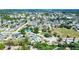 An aerial neighborhood view with an overview of the roofs, roadways, landscaping, and commercial spaces at 4008 Cape Vista Dr, Bradenton, FL 34209