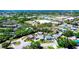 An aerial view of a neighborhood featuring well-maintained homes, mature trees, swimming pools, and convenient street access at 4008 Cape Vista Dr, Bradenton, FL 34209