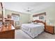 Inviting bedroom with warm wood accents, including wicker furniture, complemented by soft, natural light at 4008 Cape Vista Dr, Bradenton, FL 34209