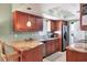 Efficient kitchen features granite countertops, wooden cabinets, and stainless steel appliances at 4008 Cape Vista Dr, Bradenton, FL 34209